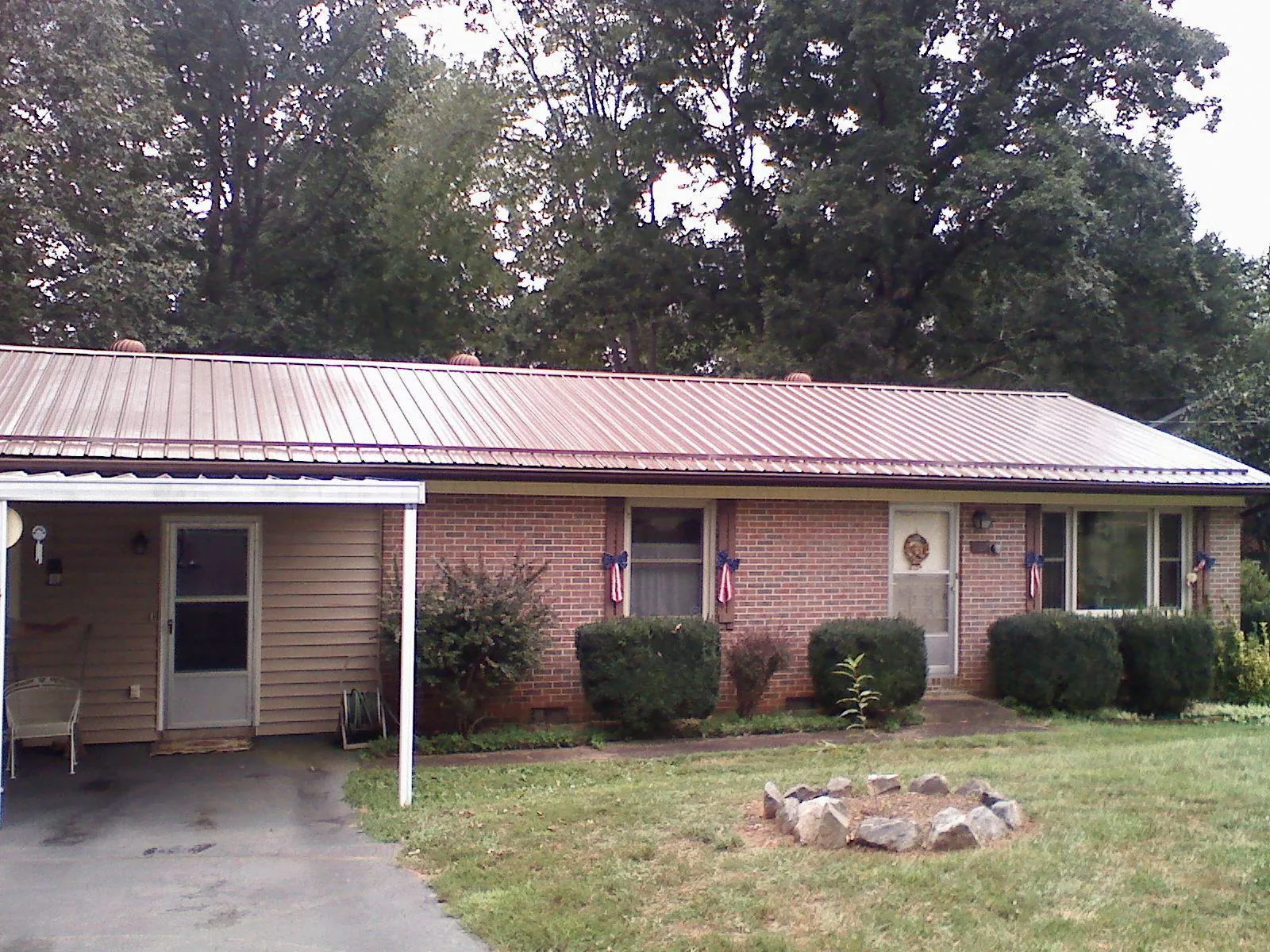 Bronze metal roof and carport on a brick ranch home — Roof Repair work by our crew in Rowland
